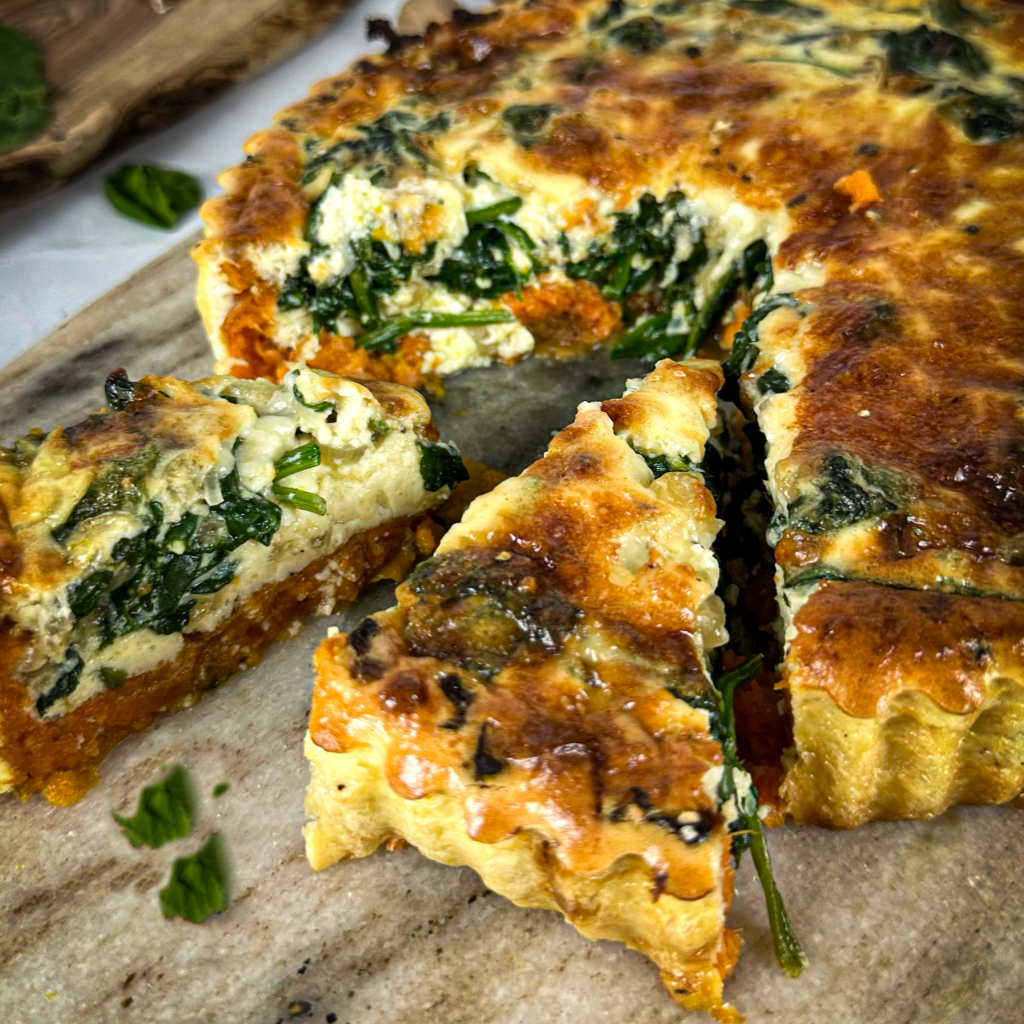 Sliced Sweet Potato Quiche Florentine showing spinach and custard filling