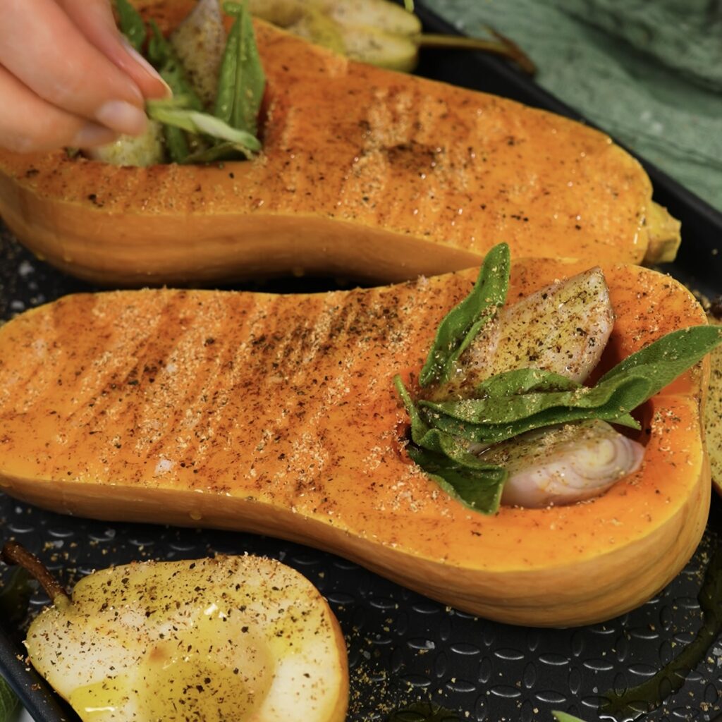 Ingredients—butternut squash, pears, shallots, and sage—on a baking tray, ready for roasting.