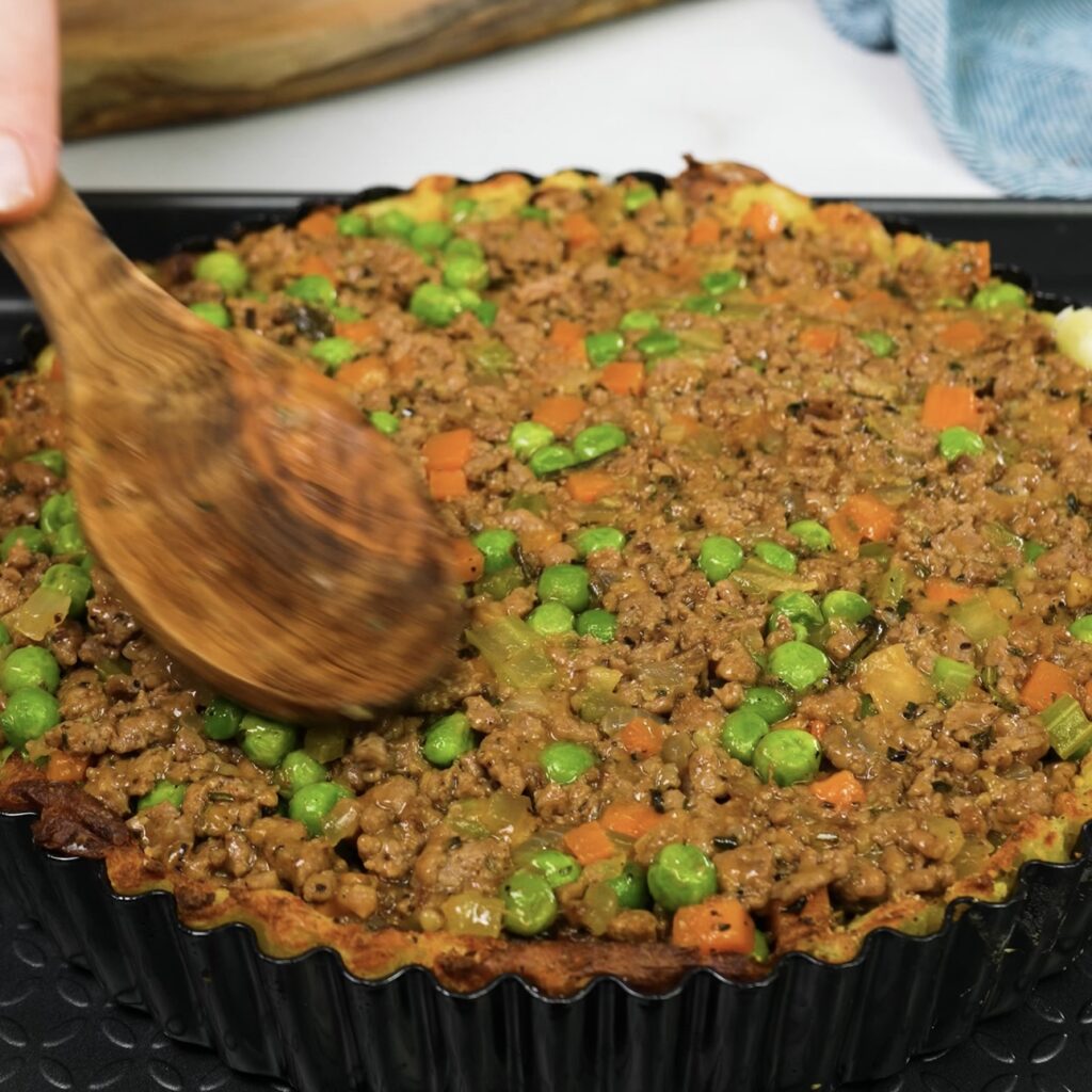 Filling of minced beef and vegetables added to the Cottage Pie.