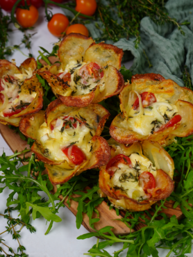 Beautifully baked potato cups filled with cheese and vegetables, garnished with fresh thyme.