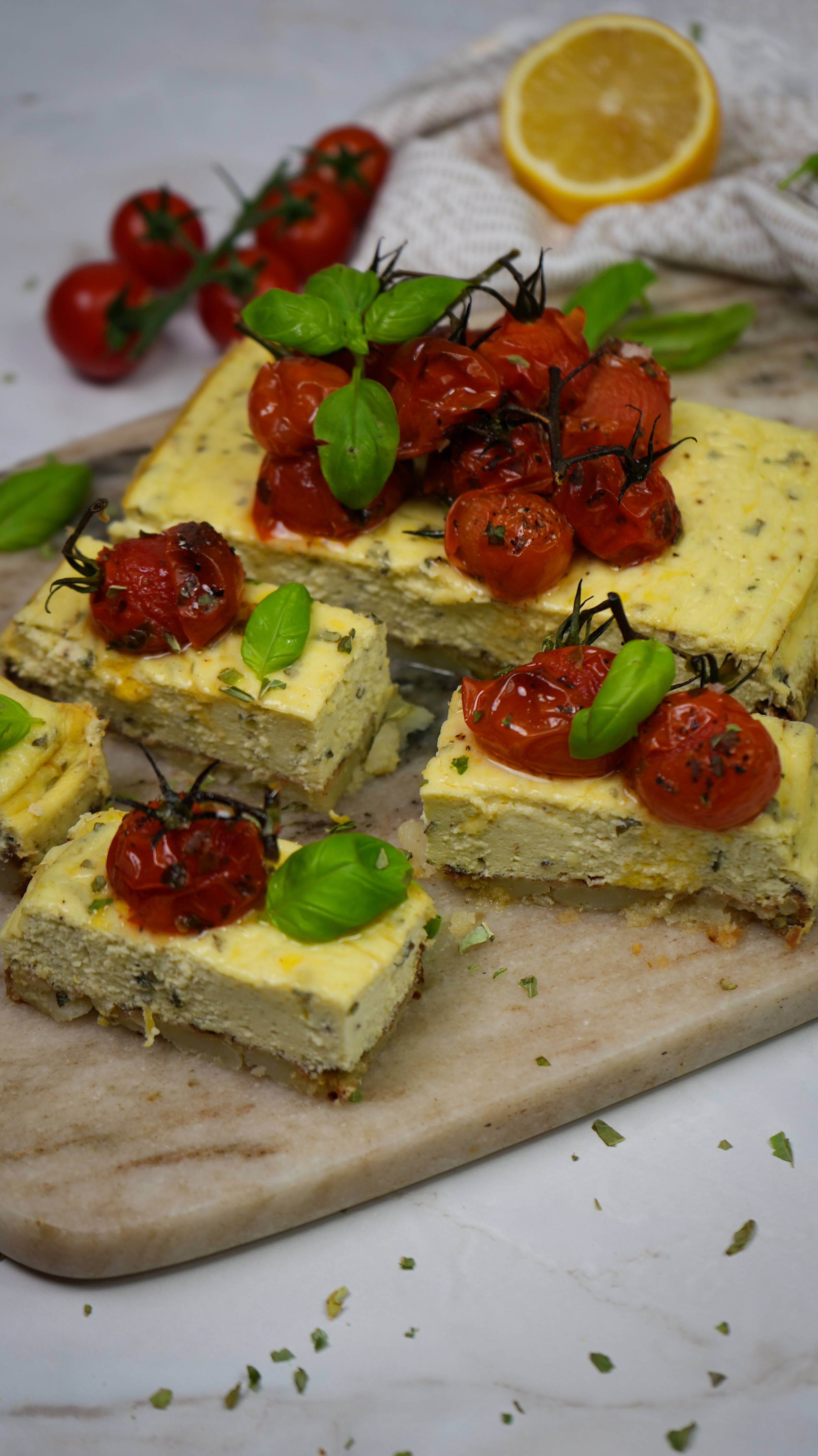 Savoury Crushed Potato Cheesecake topped with roasted cherry tomatoes