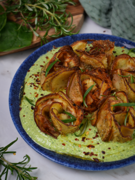 Potato roses nestled on a bed of spinach feta.