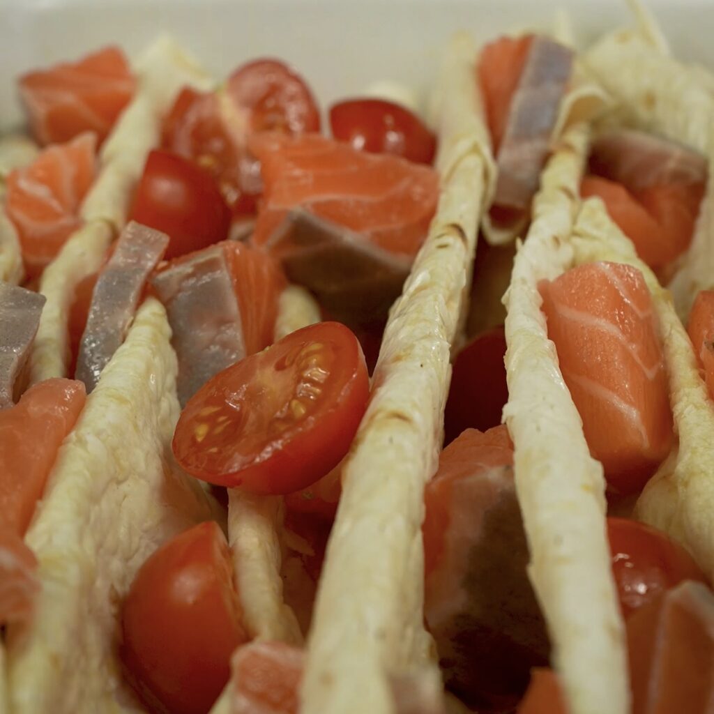 Salmon and cherry tomato filling added between folds of lavash bread.