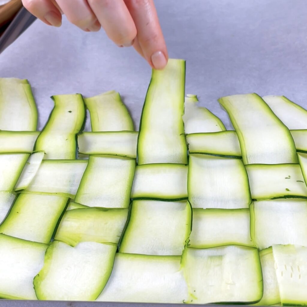 Courgette strips arranged in a woven basket pattern.