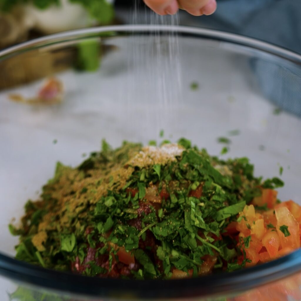 Preparing the spiced beef stuffing for stuffed onions