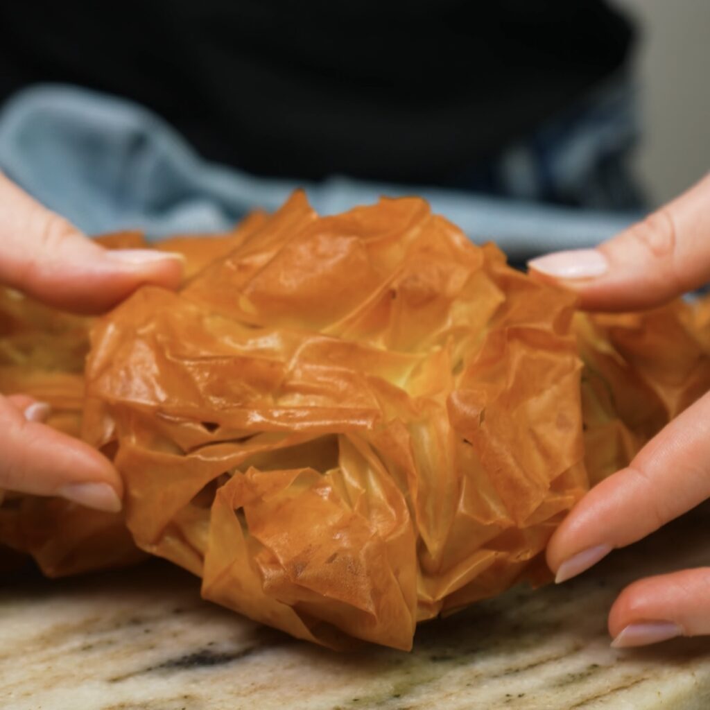 A golden, baked filo bun filled with pistachio paste.