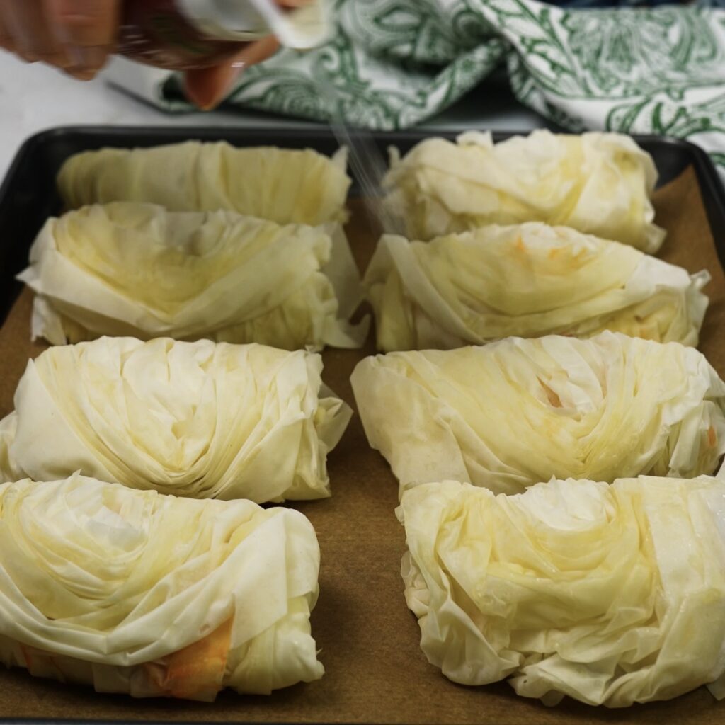 Filo pastry buns on a baking tray ready to bake.