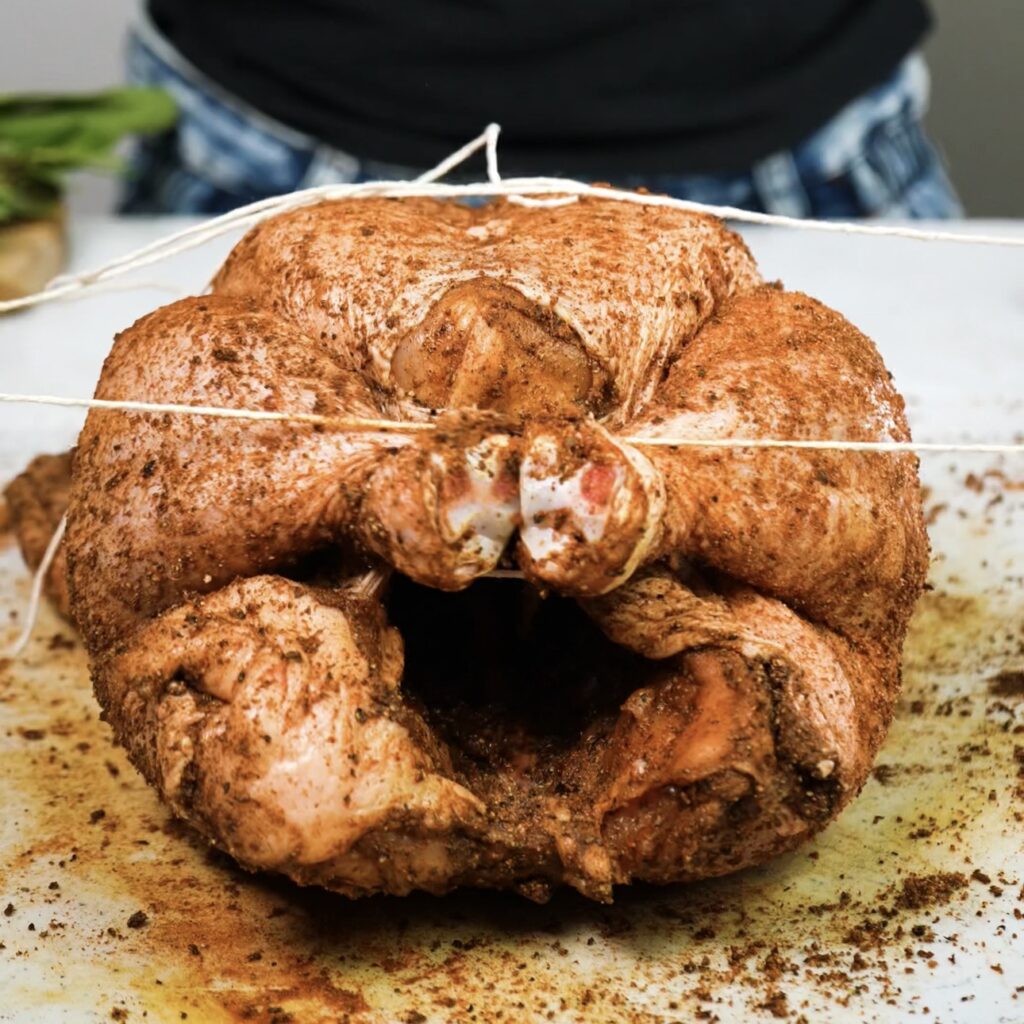 Tying chicken legs with kitchen twine for roasting