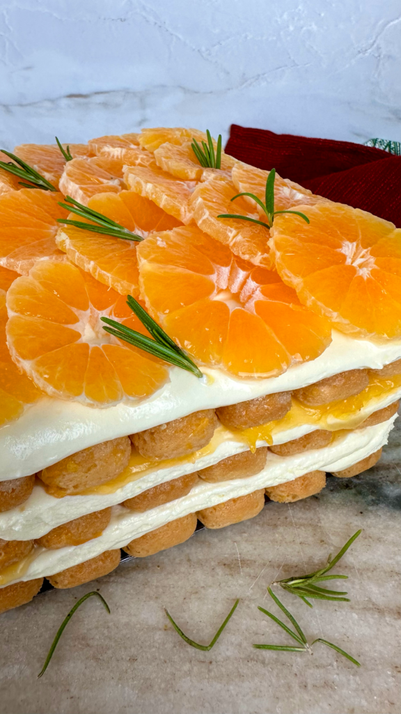 Mandarin Tiramisu topped with fresh mandarin slices and rosemary.