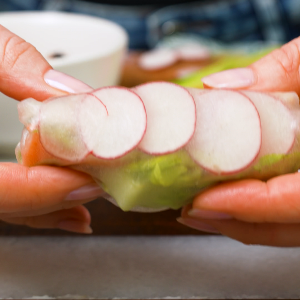 Rolled spring roll with fresh vegetables and shredded chicken.