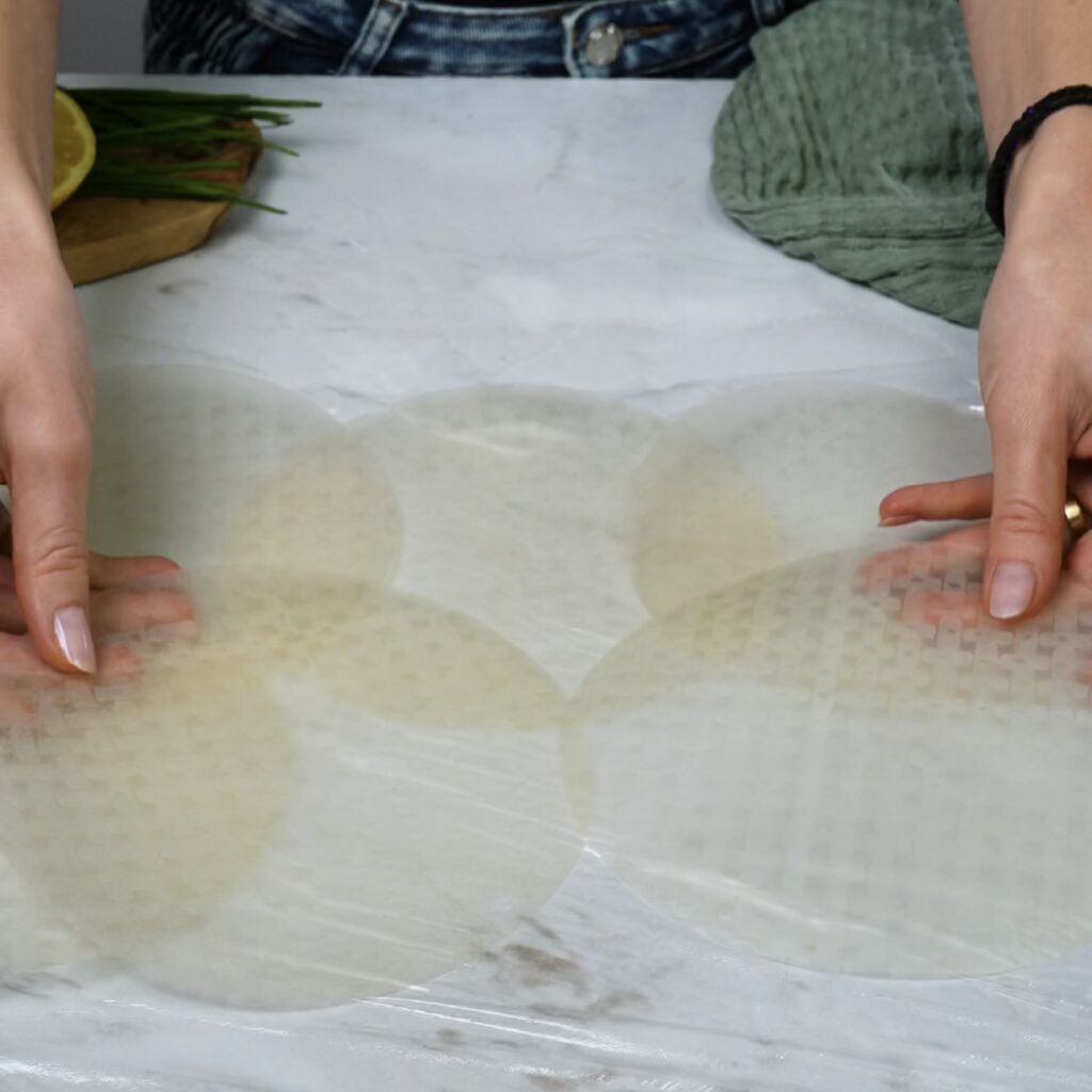 Arranging rice papers on a work surface for Rice Paper Cucumber Rolls.