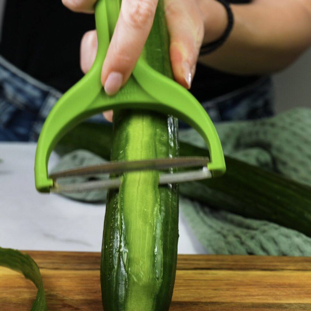 Slicing cucumber into thin strips for Rice Paper Cucumber Roll