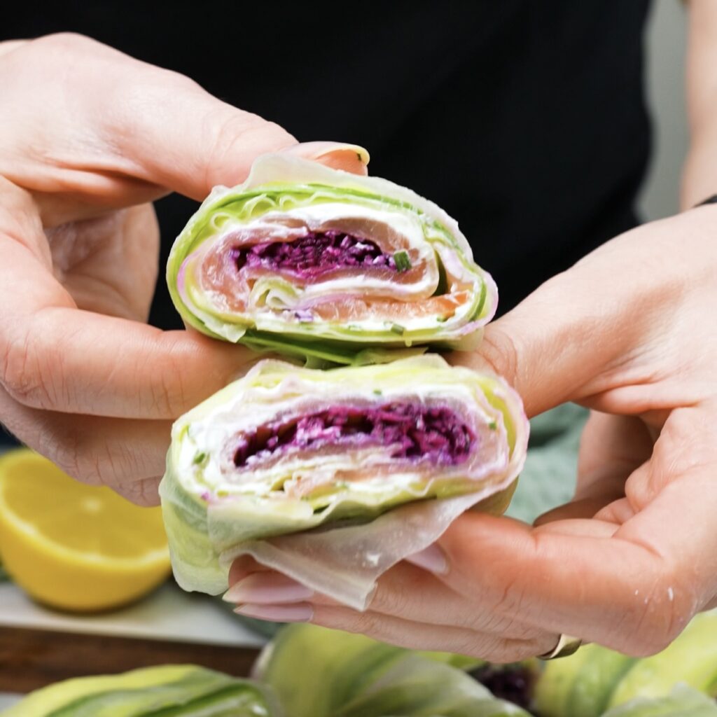 Sliced rice paper cucumber roll showing fresh ingredients inside.