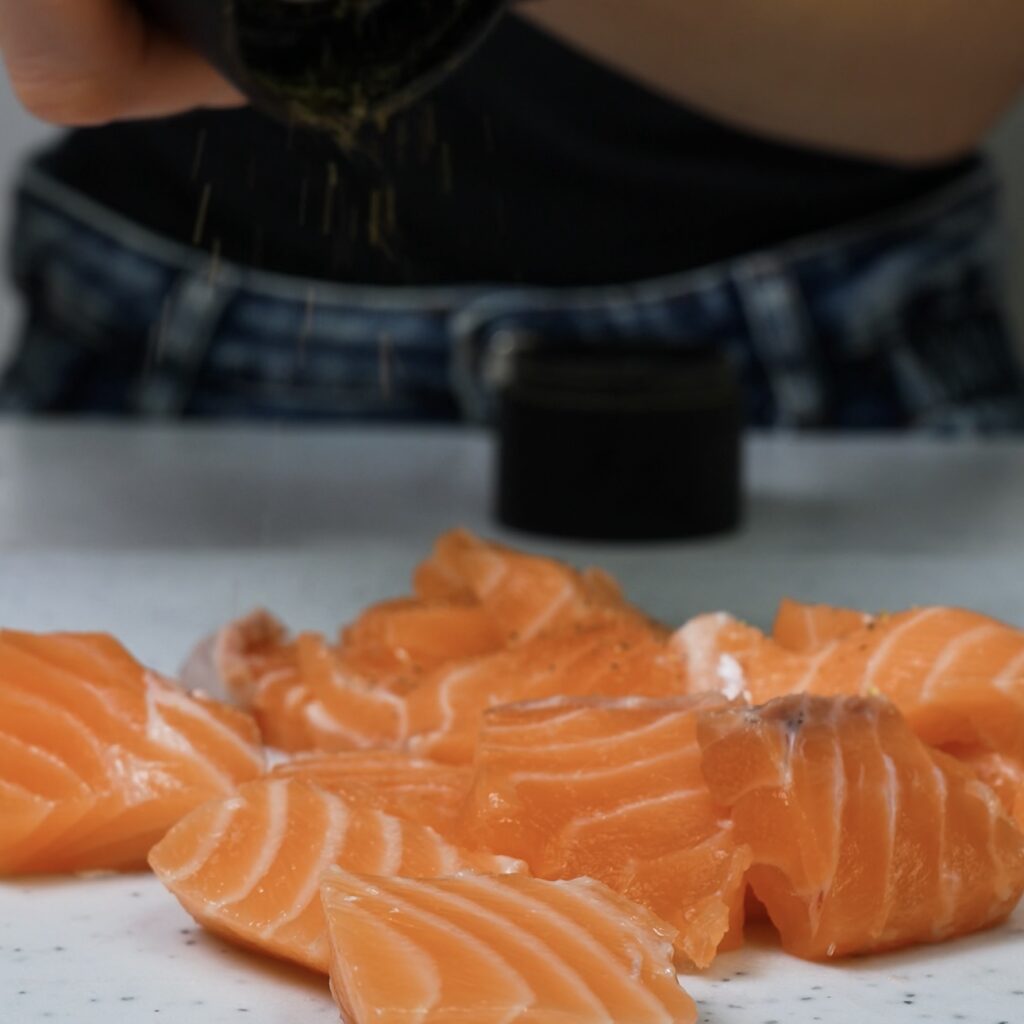 Cubed salmon seasoned with salt and pepper.