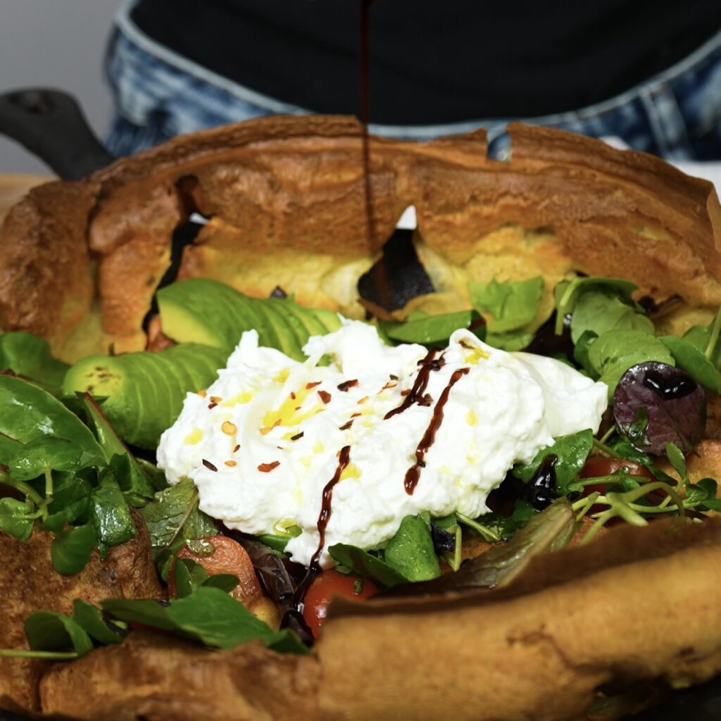 opping the Salmon Dutch Baby with fresh salad, avocado, burrata, and cherry tomatoes.