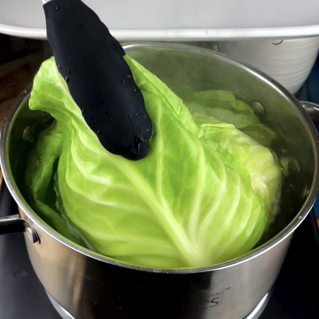 Boiling cabbage leaves to soften for giant cabbage rolls.