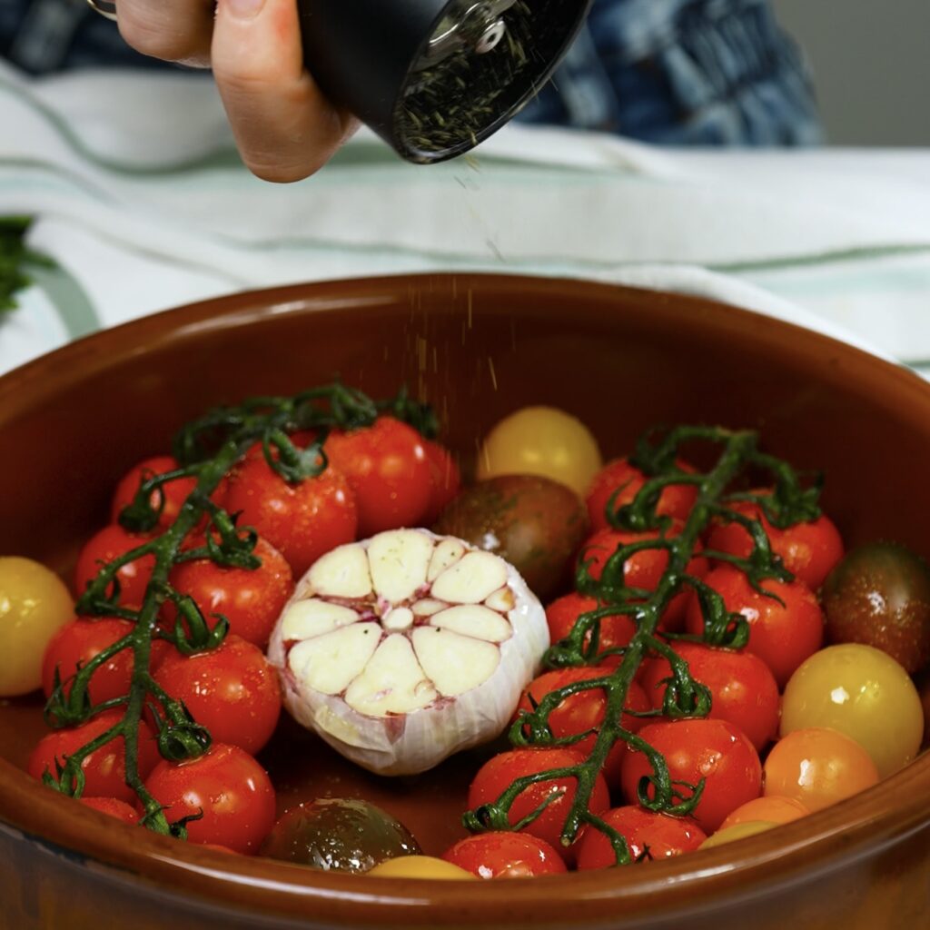 Cherry tomatoes and garlic bulb ready for roasting.