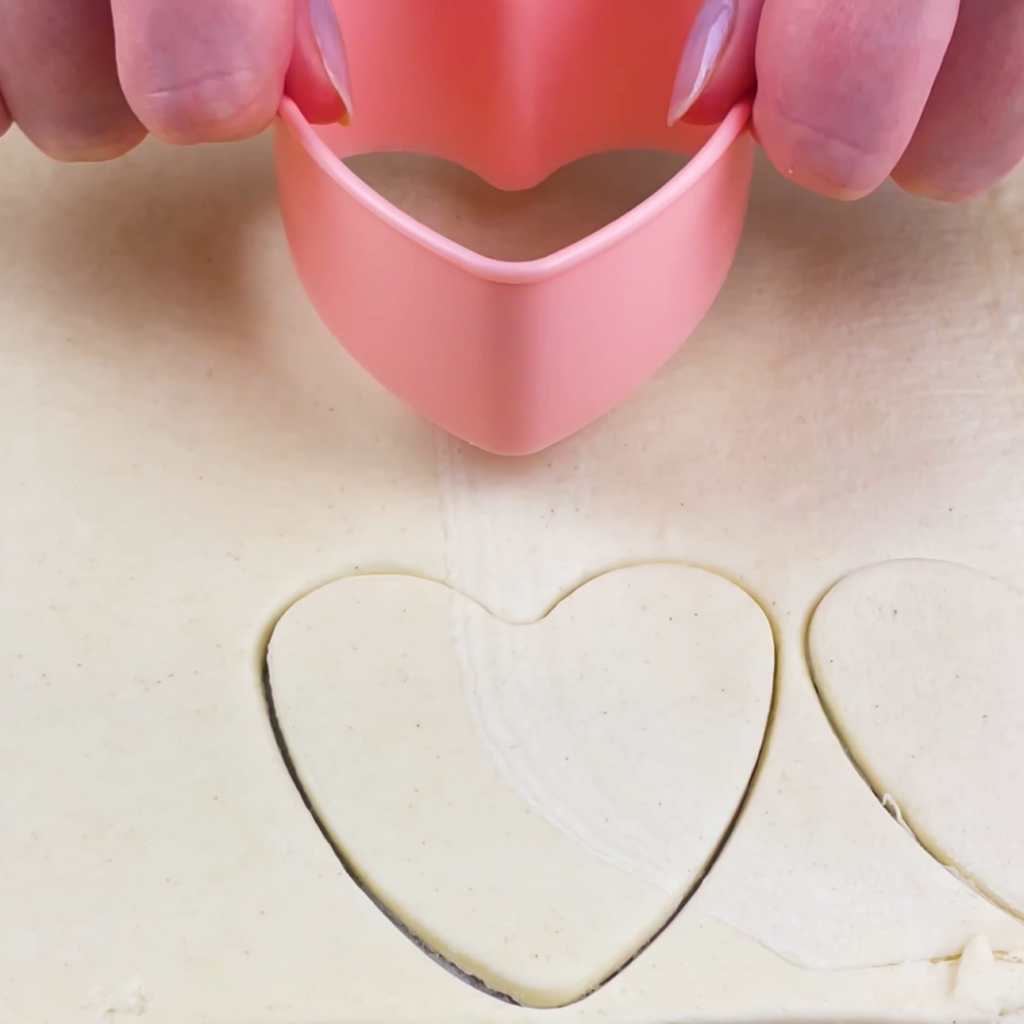 Cutting heart-shaped puff pastry.