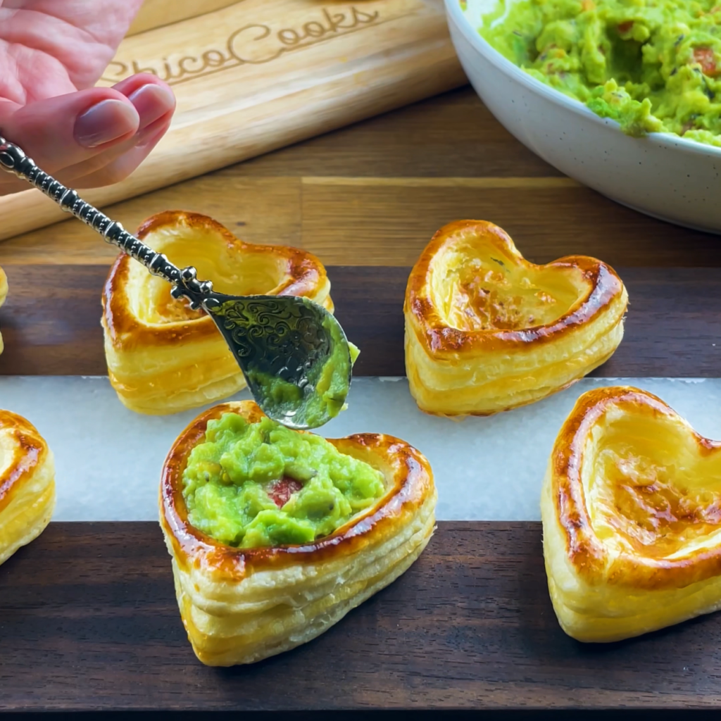 Guacamole being added to puff pastry.