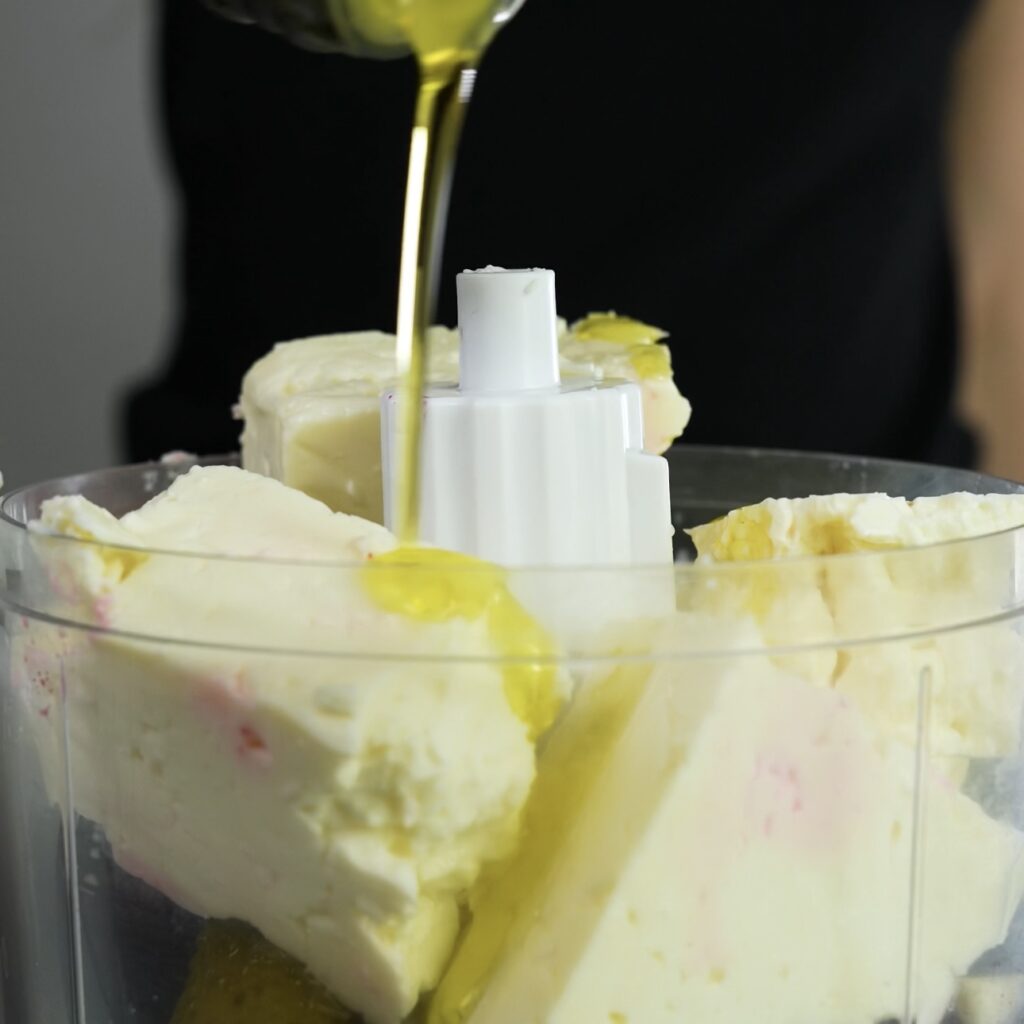 Blending beetroot, feta, and seasonings into a smooth mixture.