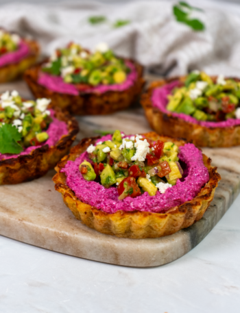 Potato tarts filled with beetroot feta and topped with avocado salsa.