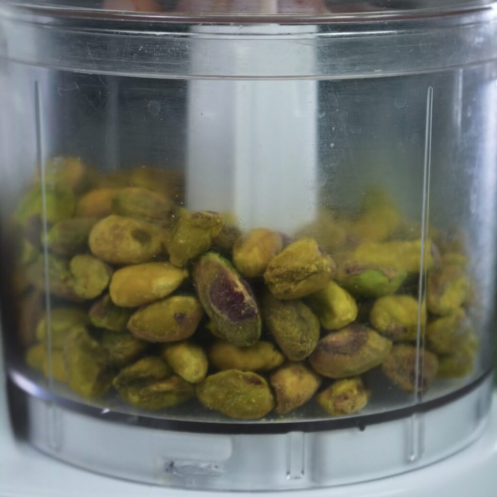 Whole pistachios in a blender, ready to be ground for baklava filling.