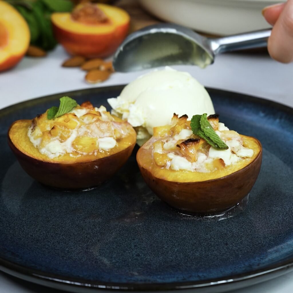 Baked nectarine with honeyed cottage cheese and almonds, served with a scoop of ice cream.