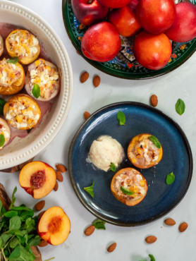 Baked nectarines in a dish and on a plate, served with a scoop of ice cream.