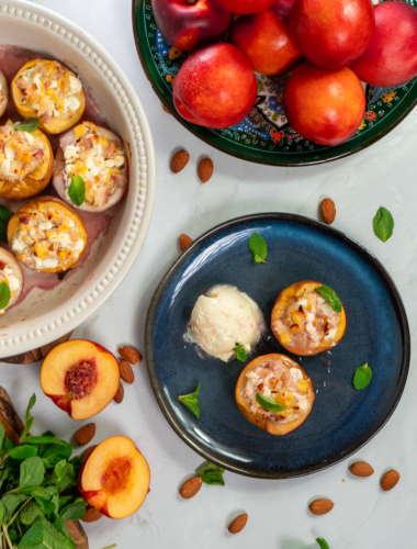 Baked nectarines in a dish and on a plate, served with a scoop of ice cream.