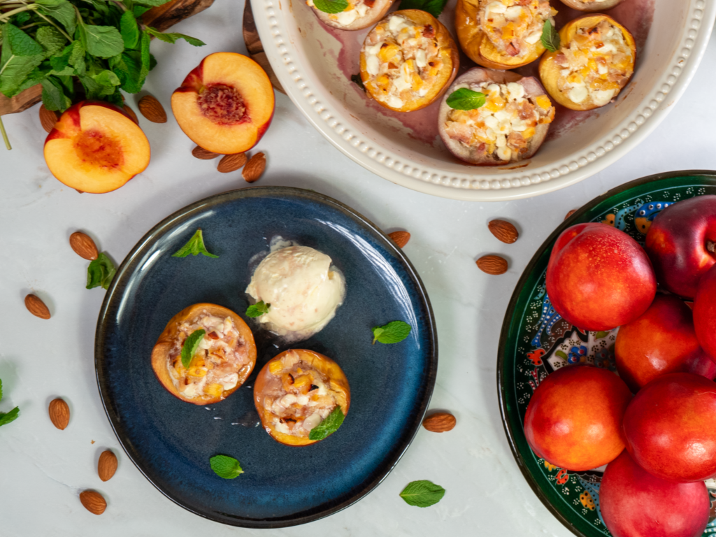 Baked nectarines in a dish and on a plate, served with a scoop of ice cream.