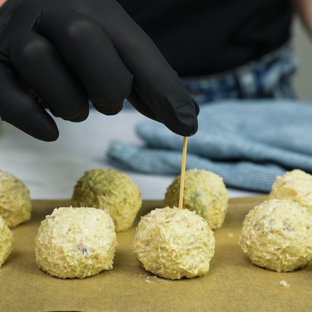 Toothpicks being inserted into bites before freezing