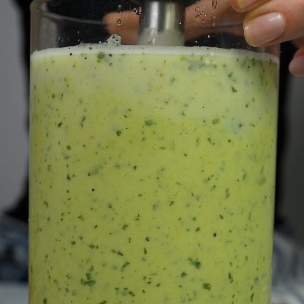 Creamy avocado soup freshly blended and ready to chill