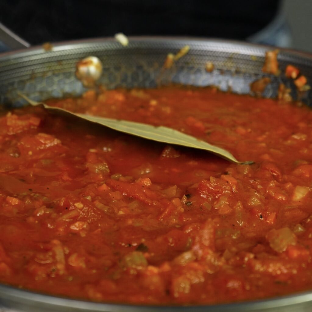 Tomato sauce simmering in a pan