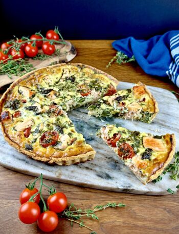 Salmon and asparagus quiche with two slices cut and slightly pulled out