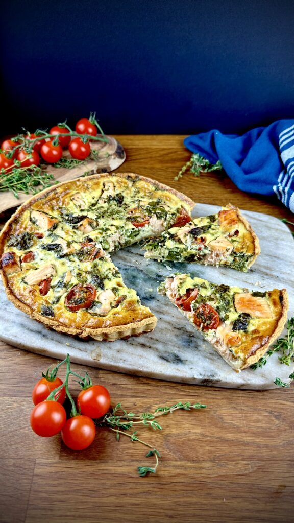 Salmon and asparagus quiche with two slices cut and slightly pulled out