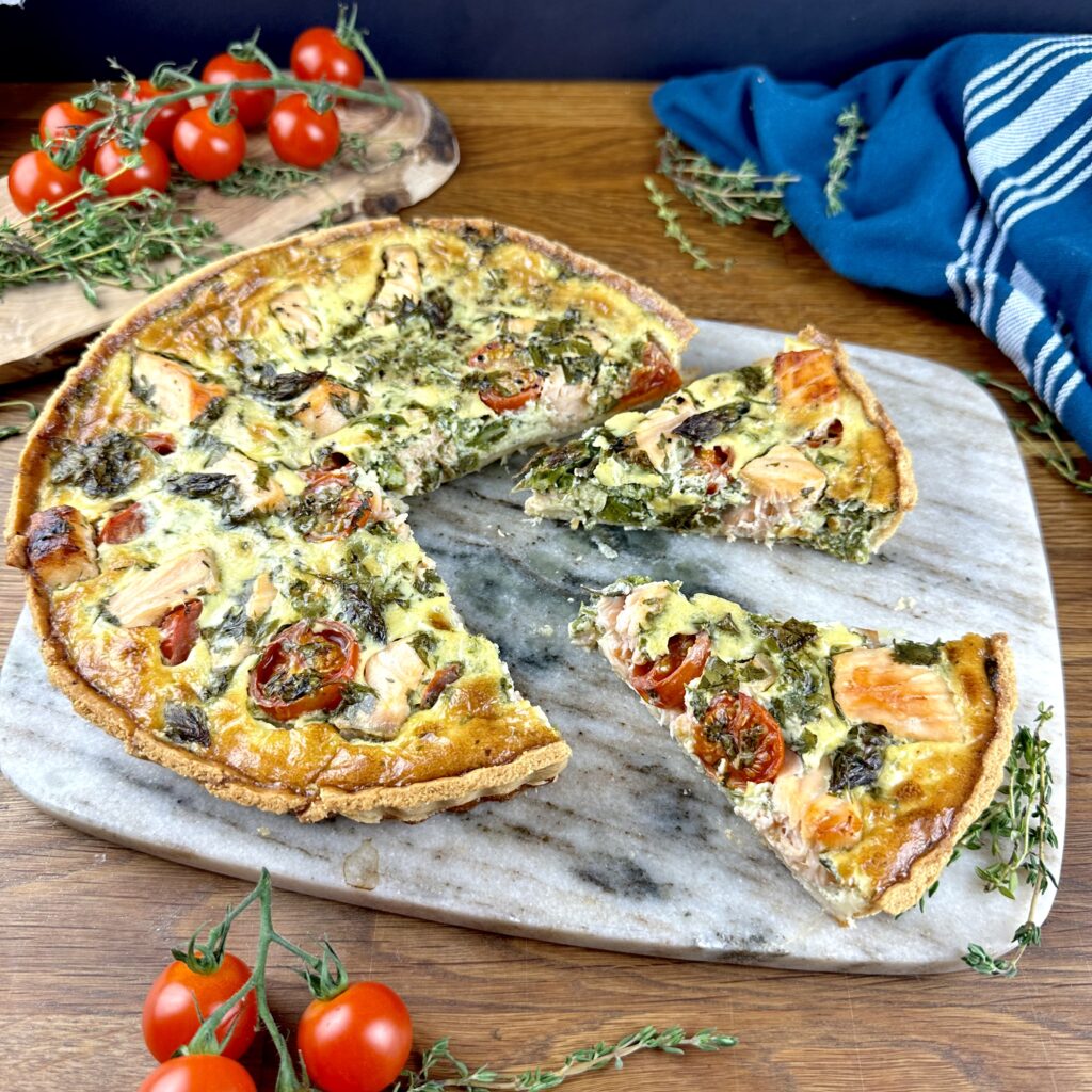 Salmon and asparagus quiche with two slices cut and slightly pulled out