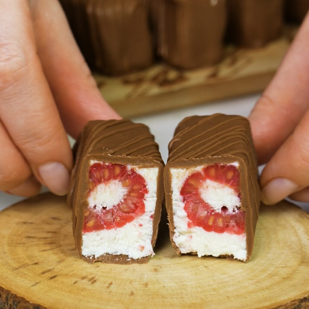 Close-up of a sliced raspberry cottage cheese bar with visible raspberries