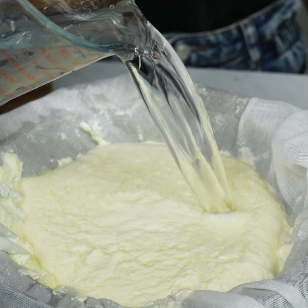 Rinsing cottage cheese curds with ice-cold water