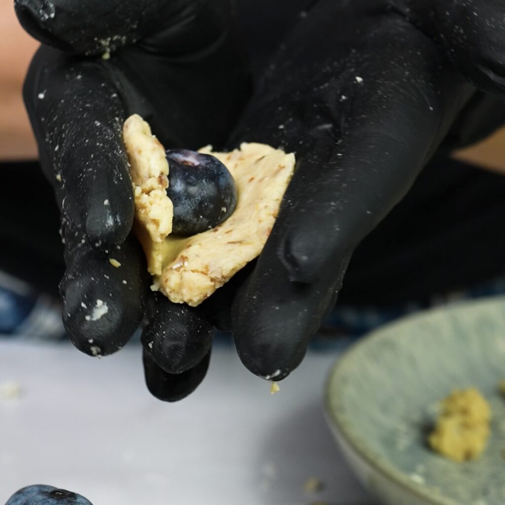 Wrapping a fresh blueberry inside cottage cheese mixture