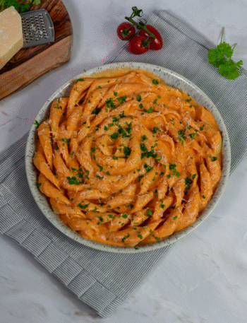 Creamy roasted tomato and cottage cheese fusilli served on a plate
