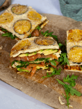 High-protein courgette squares topped with salmon, avocado, and rocket