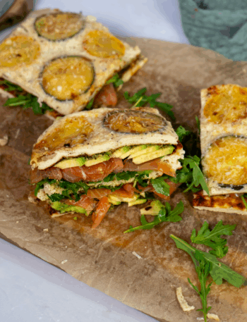 High-protein courgette squares topped with salmon, avocado, and rocket