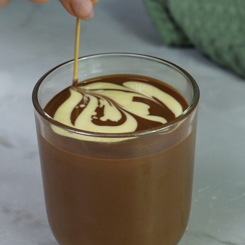 Swirling white chocolate into melted milk chocolate