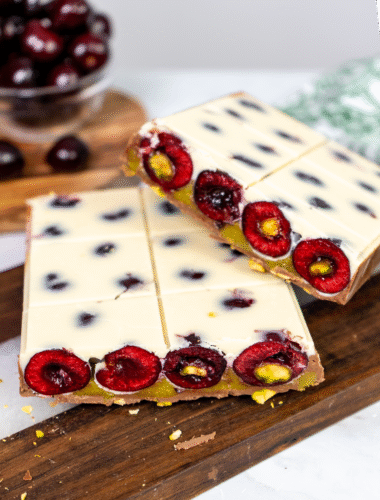Picota Cherry Pistachio Chocolate Bar sliced in half, showing layered interior