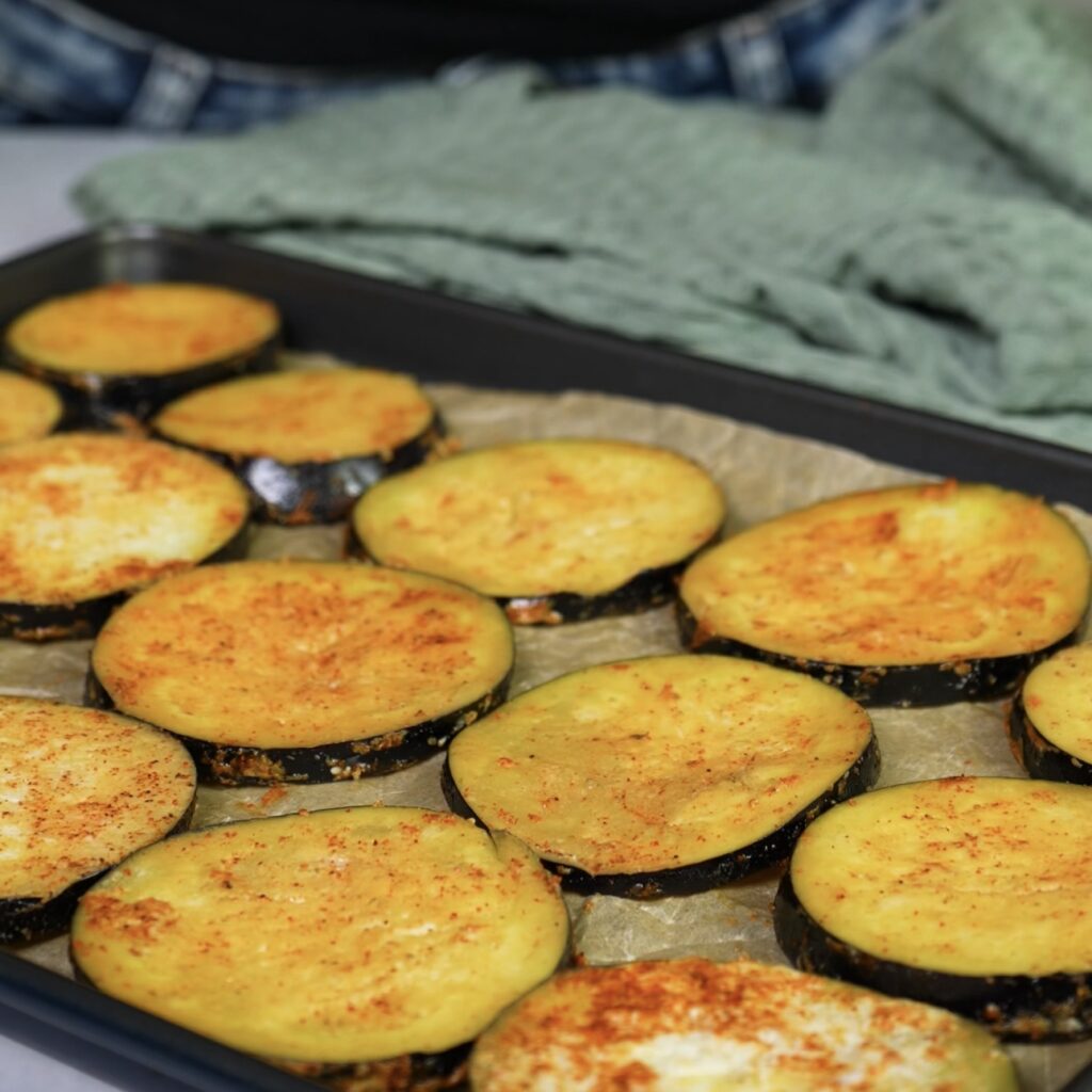 Aubergine slices arranged on a baking tray