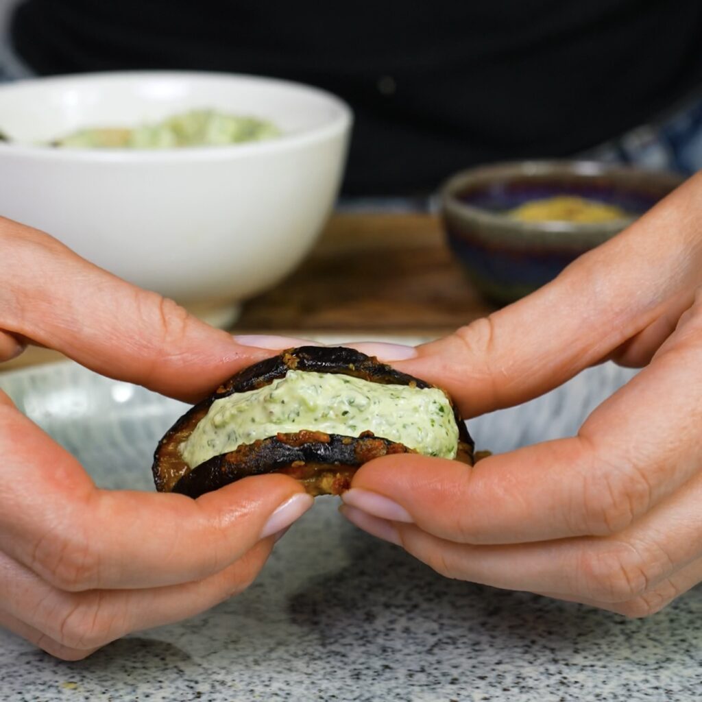 Assembling aubergine cottage cheese taco by folding slice