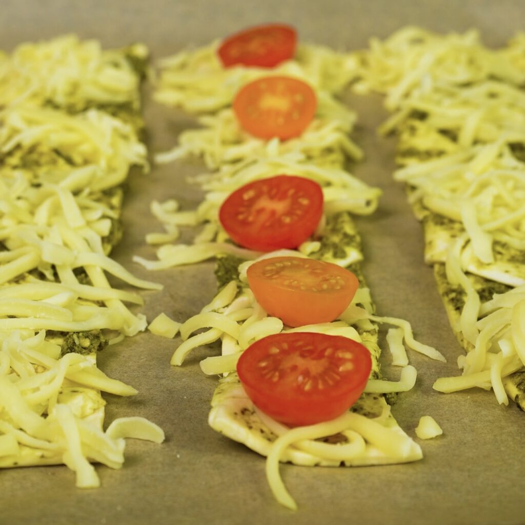 Puff pastry twists topped with mozzarella and cherry tomatoes.