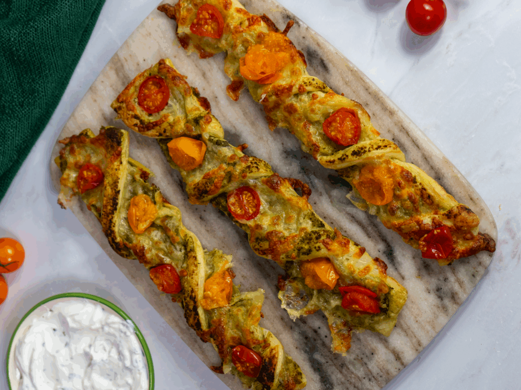 Golden pesto tomato puffs served with garlic yoghurt dip