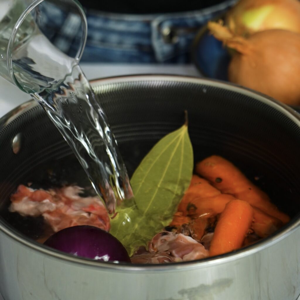 Ingredients in a pot for homemade lamb stock.