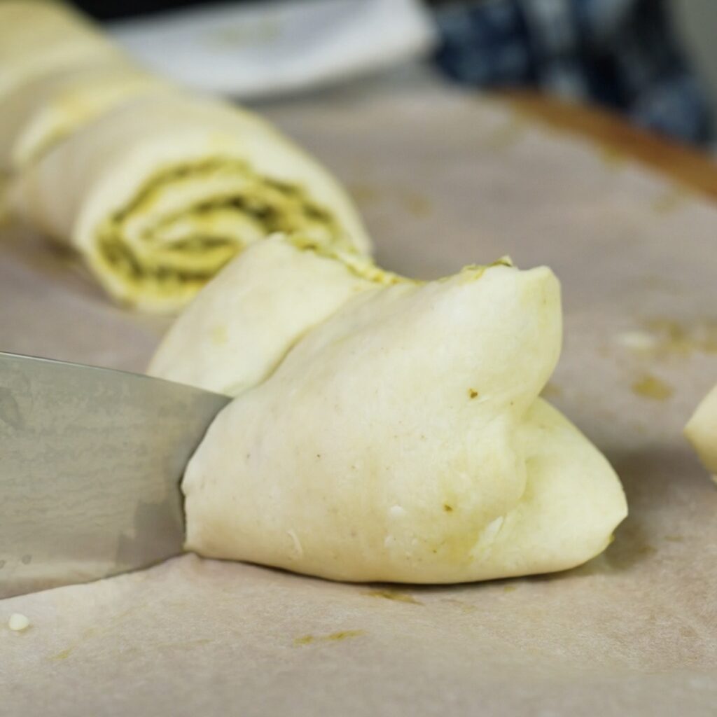 Making a slit in the folded puff pastry with a sharp knife.